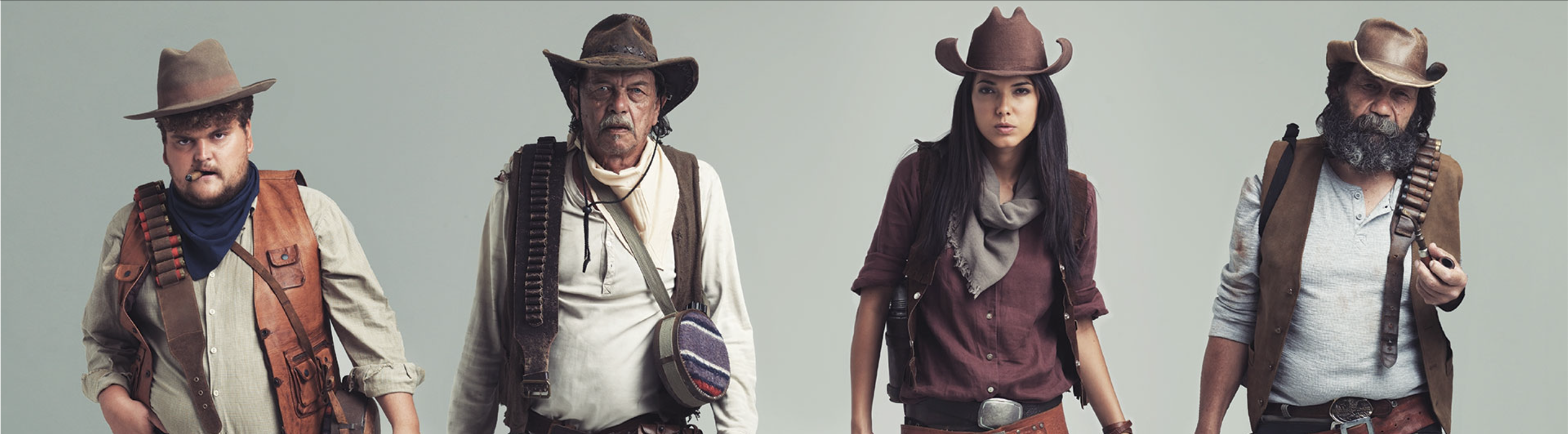 3 men and one woman dressed as cowboys