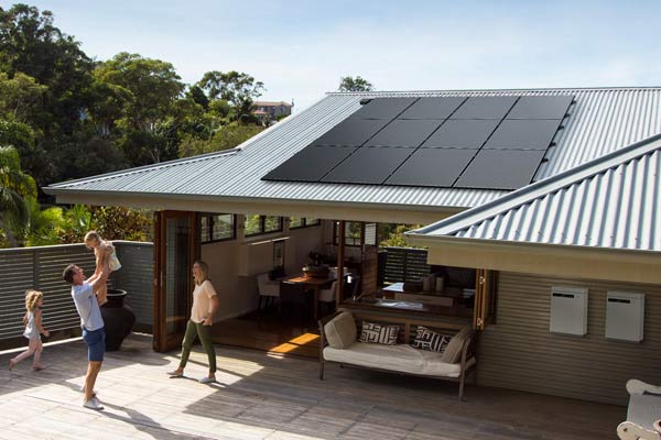 Solahart Silhouette solar panels on a home with a colorbond style roof with family in foreground